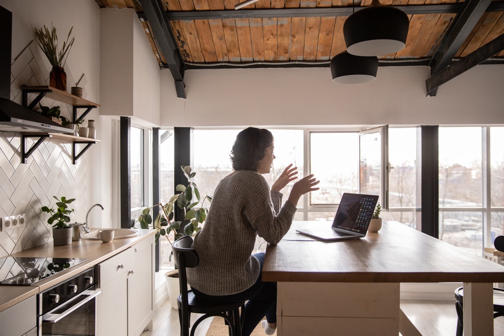 A women attending a virtual meeting from her home
