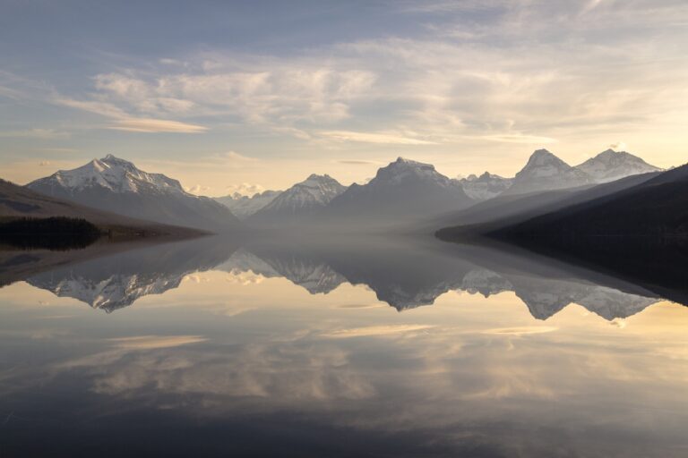 Clouds and mountains reflected in a calm lake